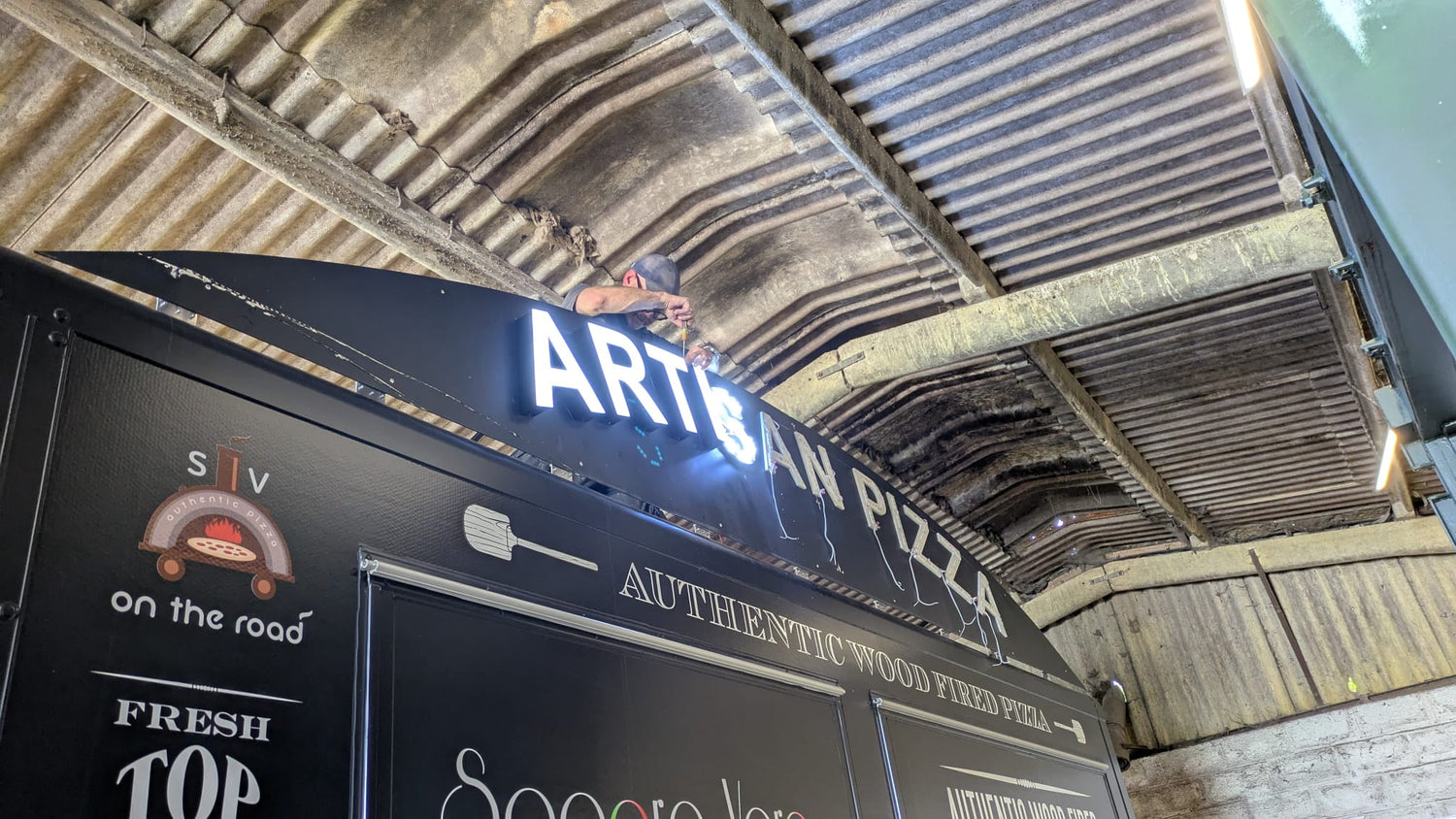 Working on the light up sign for a pizza van